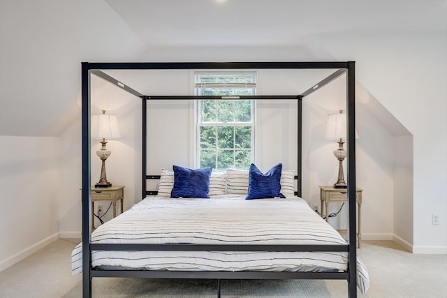 carpeted bedroom featuring vaulted ceiling