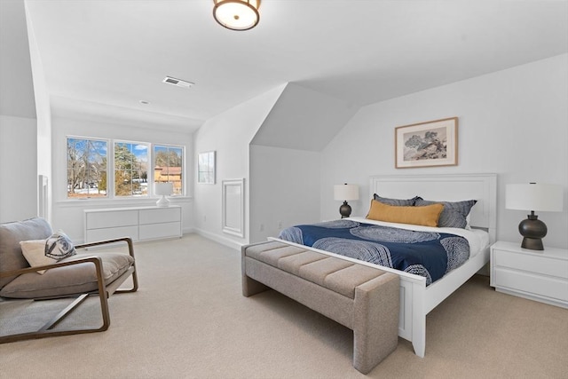 bedroom with lofted ceiling, carpet floors, and visible vents