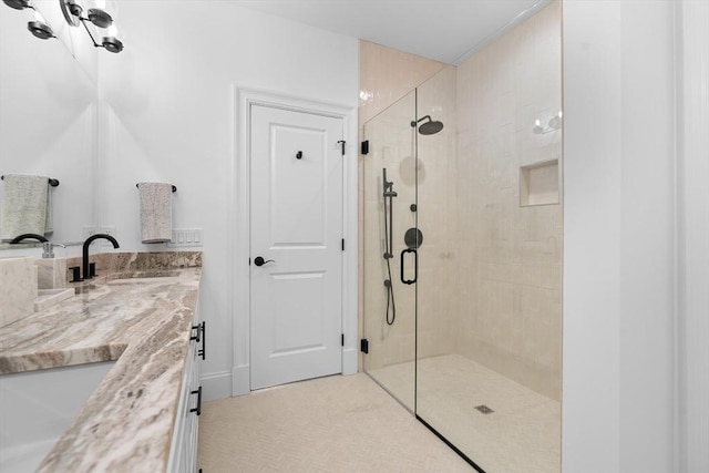 bathroom with a stall shower and vanity