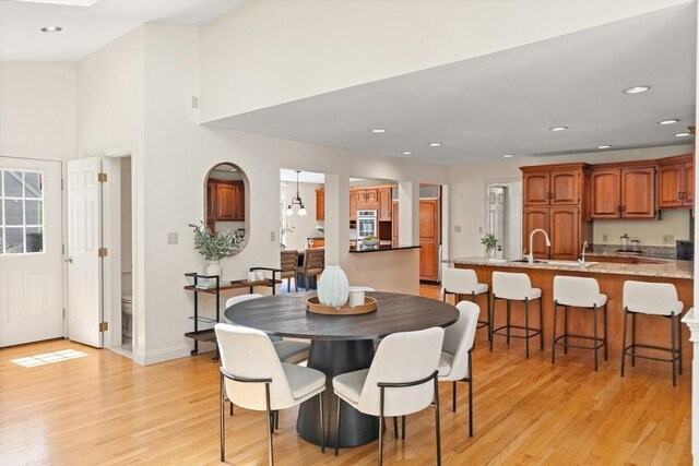 dining room with recessed lighting and light wood-style flooring