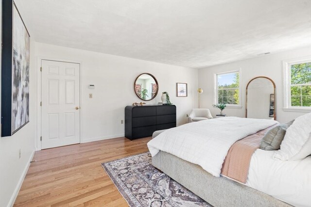bedroom featuring baseboards and light wood-style flooring