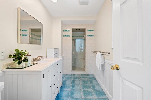 full bath featuring vanity, visible vents, and a stall shower