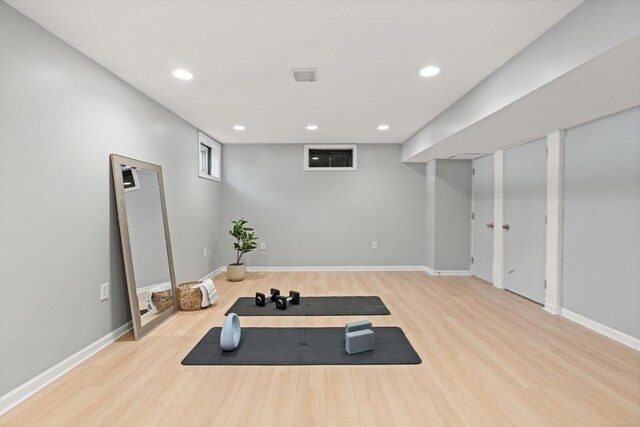 workout area featuring baseboards, recessed lighting, wood finished floors, and visible vents