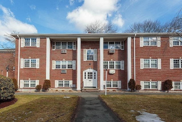 view of building exterior featuring cooling unit and entry steps