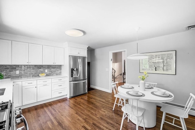 24 Gerald Rd, Marblehead, MA 01945 - kitchen featuring appliances with stainless steel finishes, light countertops, backsplash, white cabinets, and dark wood-style flooring