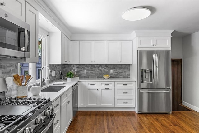 24 Gerald Rd, Marblehead, MA 01945 - kitchen featuring stainless steel appliances, light countertops, decorative backsplash, and white cabinets