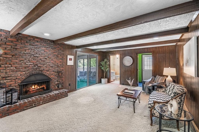 24 Gerald Rd, Marblehead, MA 01945 - living area with a textured ceiling, wooden walls, beamed ceiling, healthy amount of natural light, and carpet