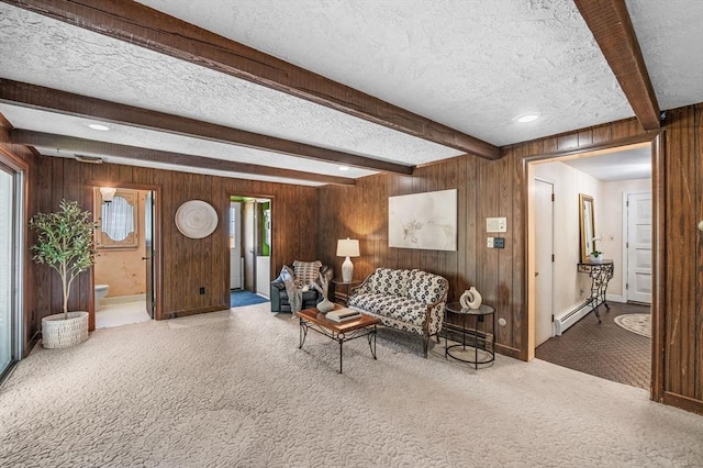 24 Gerald Rd, Marblehead, MA 01945 - living room featuring a textured ceiling, baseboard heating, beamed ceiling, carpet, and wooden walls