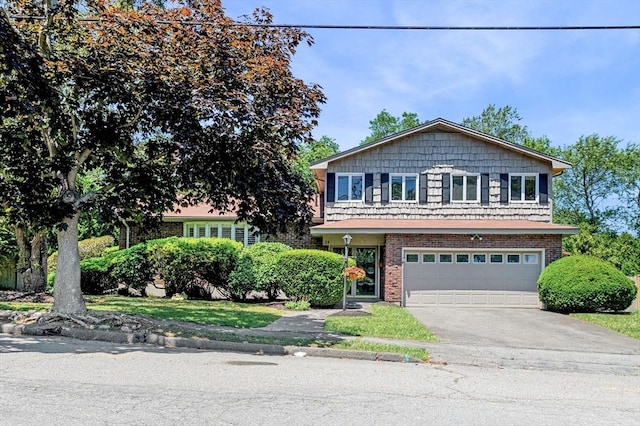 24 Gerald Rd, Marblehead, MA 01945 - view of front of home featuring an attached garage, concrete driveway, and brick siding