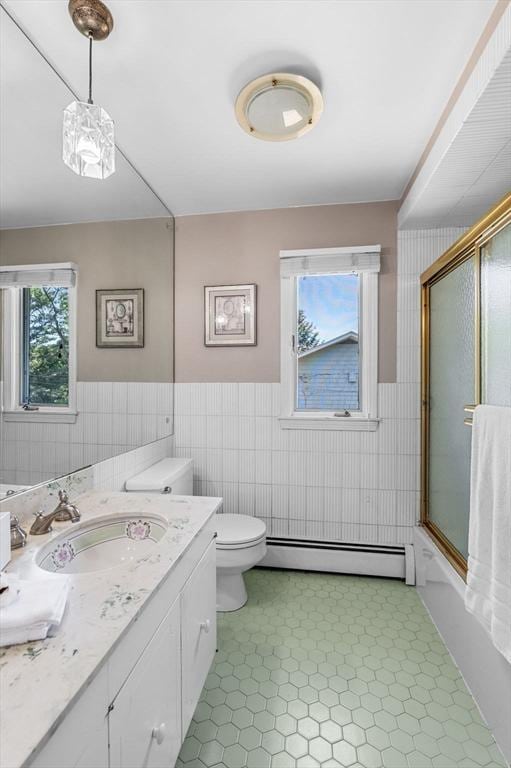 24 Gerald Rd, Marblehead, MA 01945 - full bath with baseboard heating, vanity, wainscoting, tile walls, and combined bath / shower with glass door