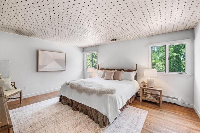 24 Gerald Rd, Marblehead, MA 01945 - bedroom featuring a baseboard heating unit and wood finished floors
