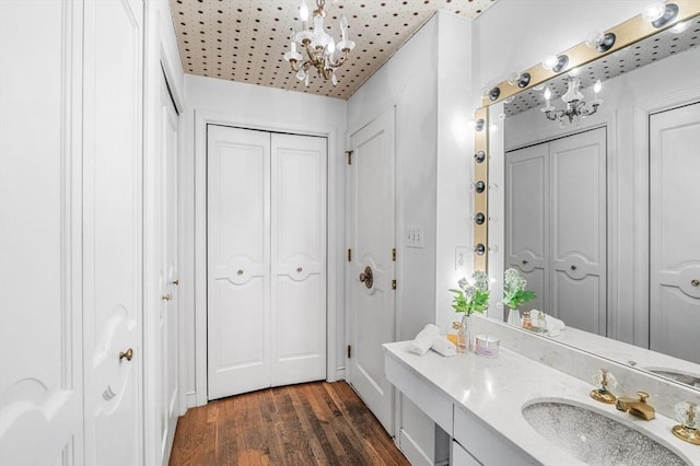 24 Gerald Rd, Marblehead, MA 01945 - bathroom with a closet, a chandelier, vanity, and wood finished floors