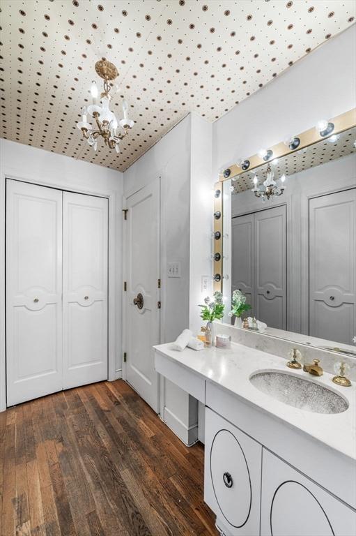 24 Gerald Rd, Marblehead, MA 01945 - bathroom with a chandelier, wood finished floors, vanity, and a closet