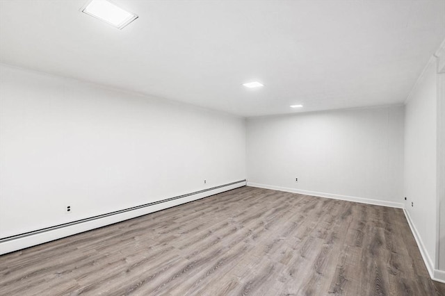 24 Gerald Rd, Marblehead, MA 01945 - empty room featuring a baseboard heating unit, wood finished floors, and recessed lighting
