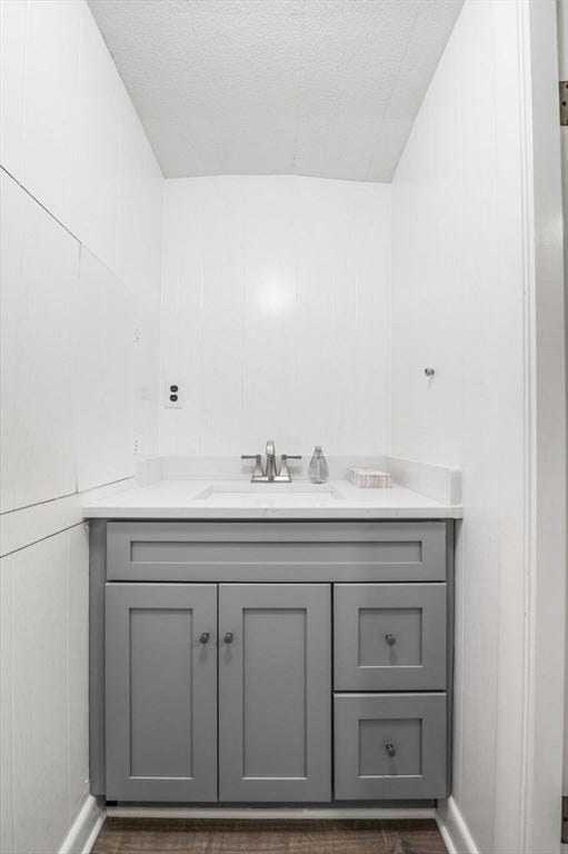 24 Gerald Rd, Marblehead, MA 01945 - bathroom with vanity, a textured ceiling, and wood finished floors