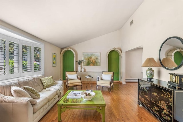 24 Gerald Rd, Marblehead, MA 01945 - living room featuring arched walkways, vaulted ceiling, wood finished floors, and a baseboard heating unit