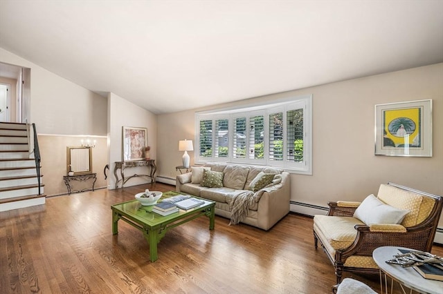 24 Gerald Rd, Marblehead, MA 01945 - living room featuring a baseboard radiator, vaulted ceiling, wood finished floors, and stairway