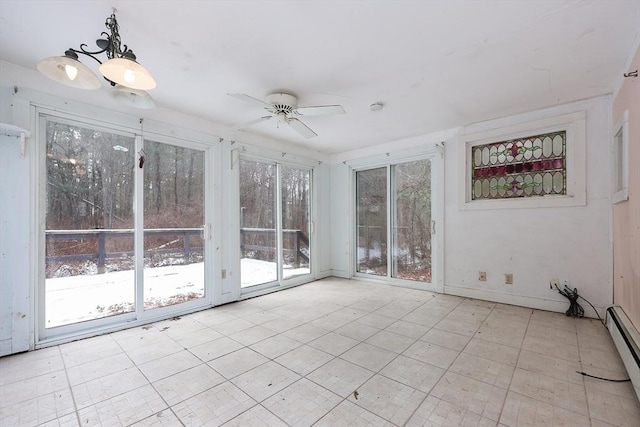 unfurnished sunroom with ceiling fan, plenty of natural light, and a baseboard radiator