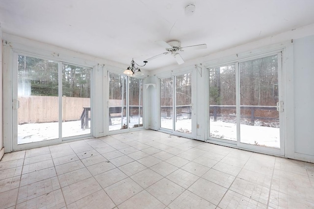 unfurnished sunroom featuring ceiling fan