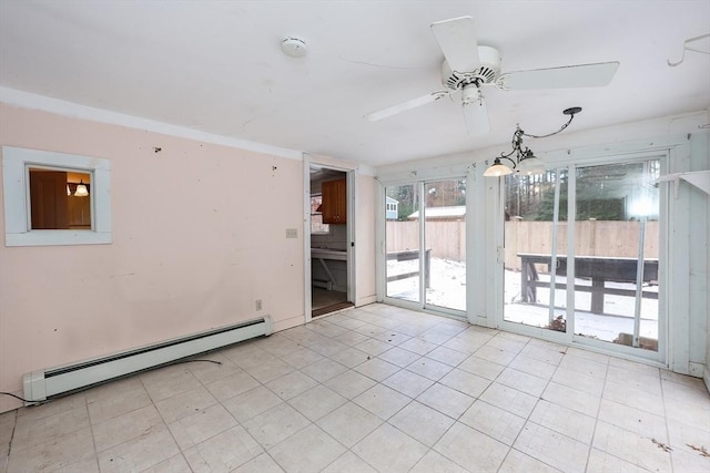 empty room featuring ceiling fan and a baseboard heating unit