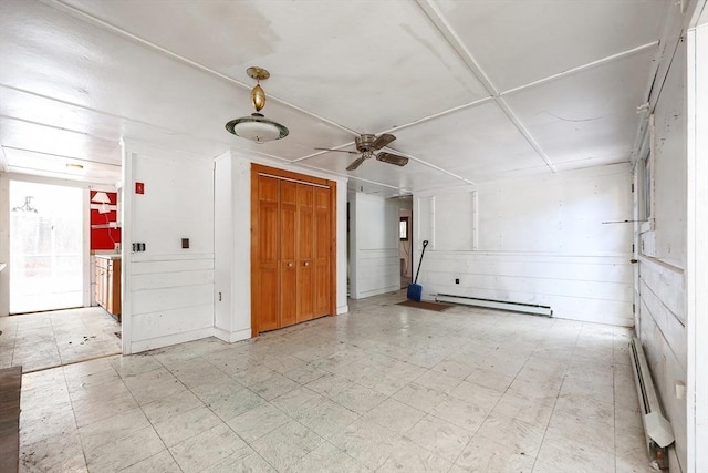 spare room featuring ceiling fan and baseboard heating