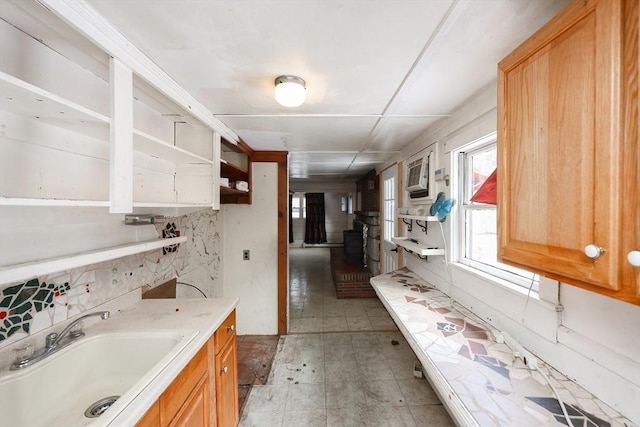 kitchen featuring an AC wall unit and sink