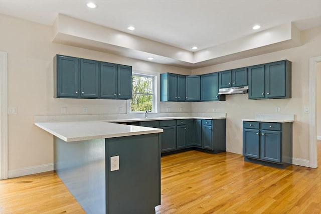 20 Miller St, Rehoboth, MA 02769 - kitchen with a peninsula, light wood finished floors, a kitchen breakfast bar, baseboards, and recessed lighting