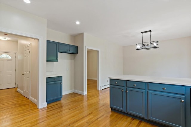 20 Miller St, Rehoboth, MA 02769 - kitchen with blue cabinets, a baseboard radiator, light wood-style flooring, light countertops, and hanging light fixtures