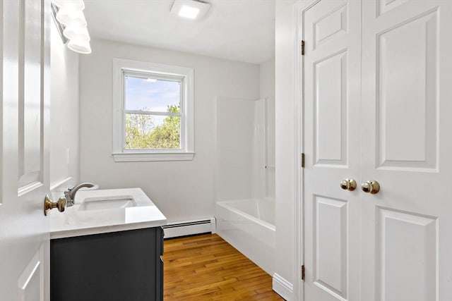 20 Miller St, Rehoboth, MA 02769 - full bath with a baseboard heating unit, wood finished floors, vanity, and bathing tub / shower combination