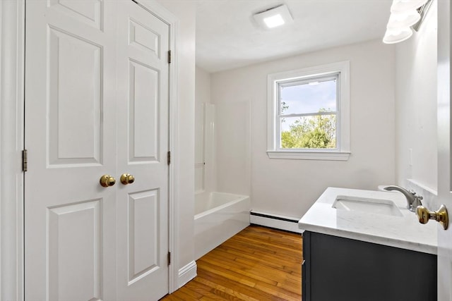 20 Miller St, Rehoboth, MA 02769 - bathroom featuring a baseboard radiator, vanity, wood finished floors, and tub / shower combination