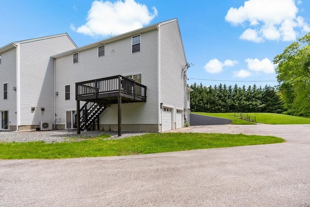 20 Miller St, Rehoboth, MA 02769 - rear view of property with a deck, an attached garage, stairway, and asphalt driveway