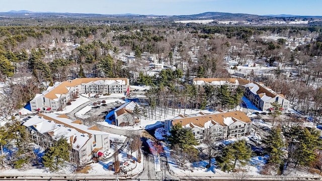 snowy aerial view with a mountain view