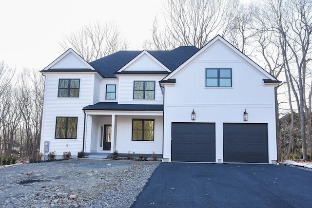 modern inspired farmhouse with covered porch and a garage