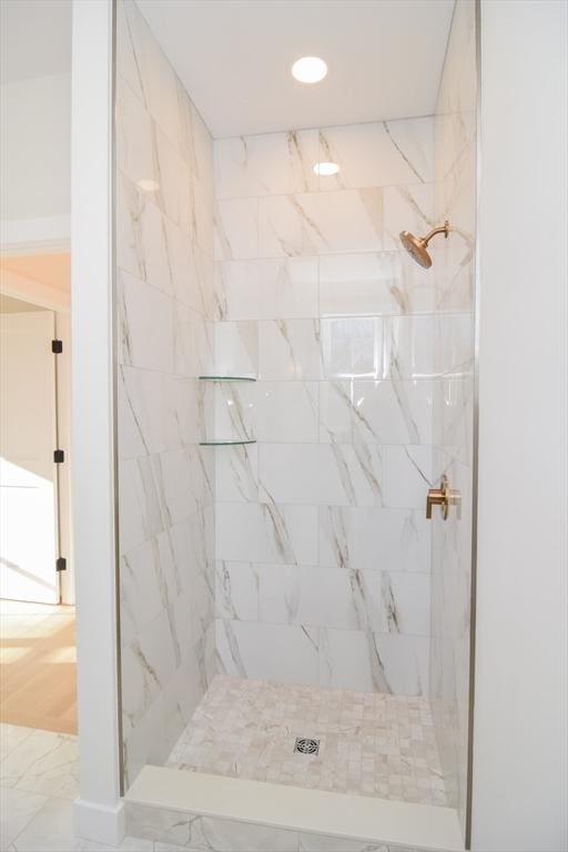 bathroom with a tile shower