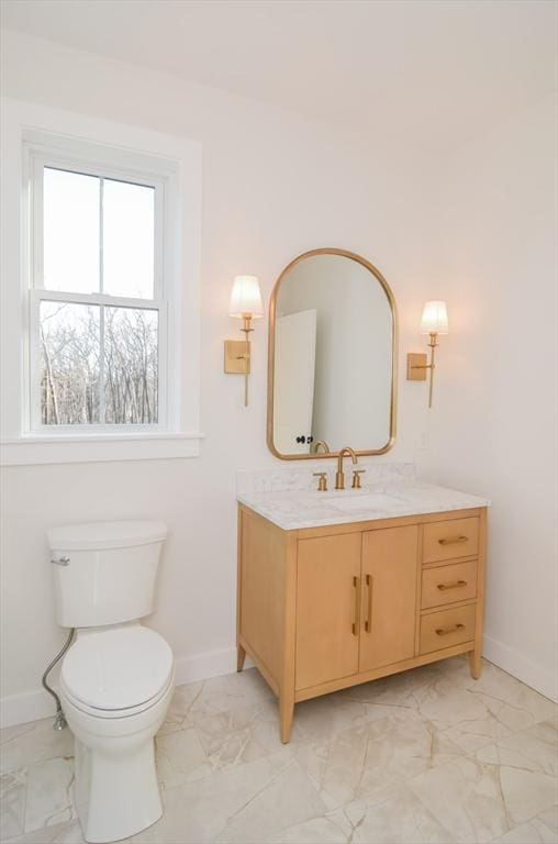 bathroom featuring toilet and vanity