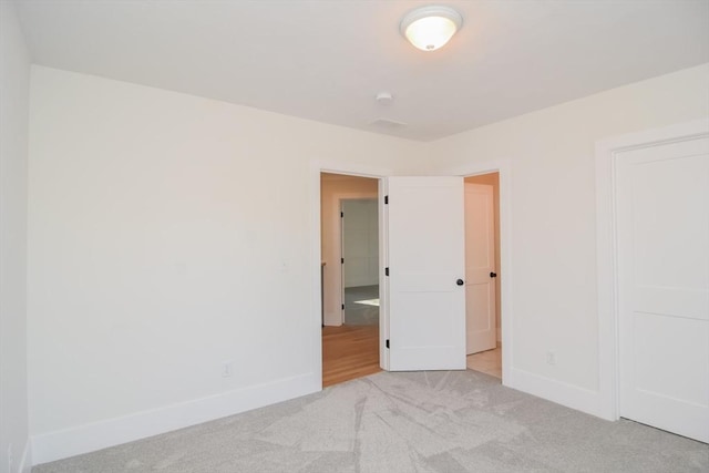 unfurnished bedroom with light carpet