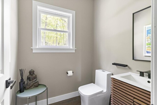 122 Green St, Northborough, MA 01532 - half bath with toilet, vanity, baseboards, and wood finished floors