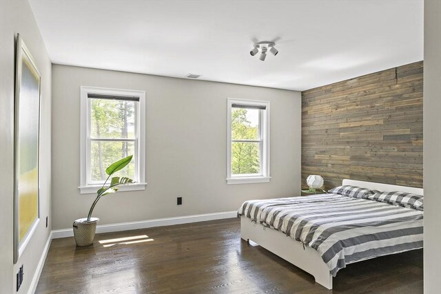 122 Green St, Northborough, MA 01532 - bedroom featuring multiple windows, wood walls, wood finished floors, and baseboards