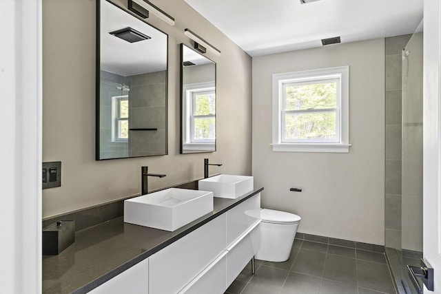 122 Green St, Northborough, MA 01532 - bathroom with plenty of natural light, double vanity, toilet, and tile patterned flooring