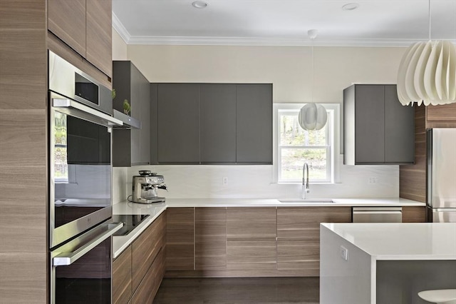 122 Green St, Northborough, MA 01532 - kitchen with modern cabinets, a sink, appliances with stainless steel finishes, and crown molding