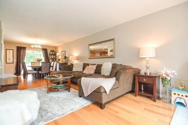 living room with a notable chandelier and light wood finished floors