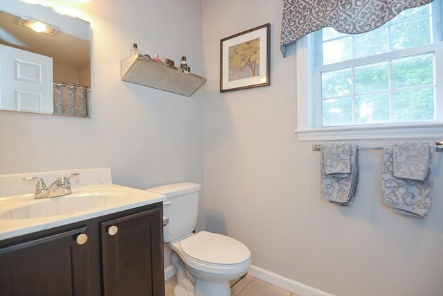 full bathroom with baseboards, toilet, vanity, and tile patterned flooring