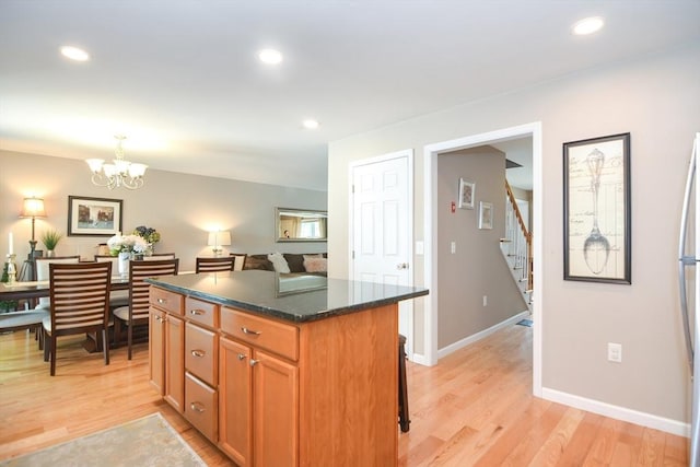 kitchen featuring light wood finished floors, recessed lighting, and a center island