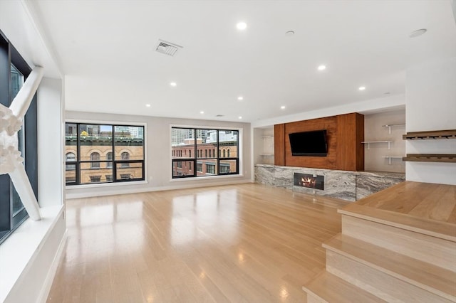 unfurnished living room featuring light wood-type flooring