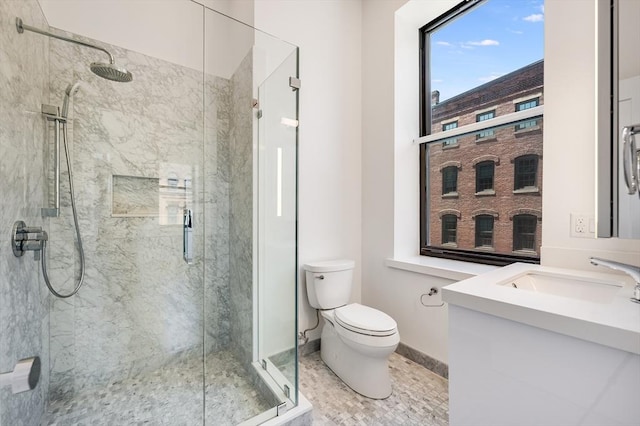 bathroom featuring vanity, an enclosed shower, tile patterned flooring, and toilet