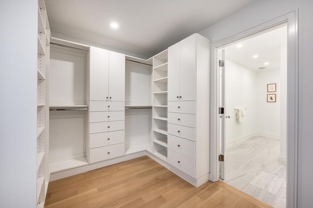 walk in closet featuring light hardwood / wood-style flooring