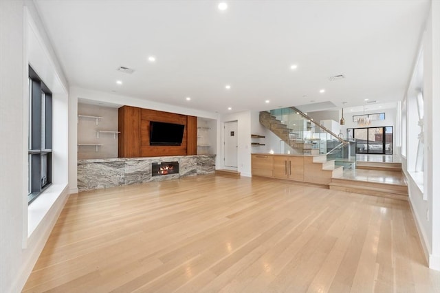 unfurnished living room featuring a fireplace and light wood-type flooring