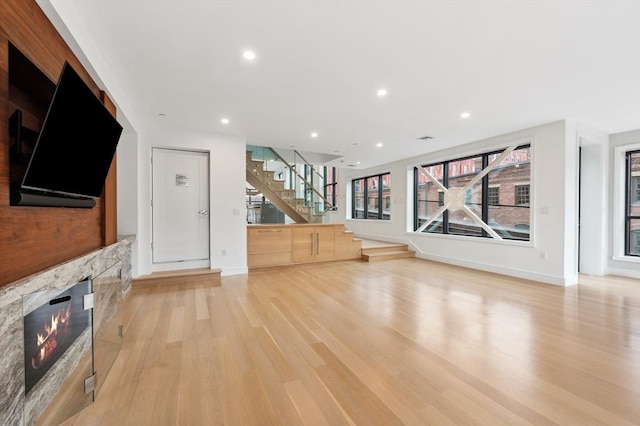 unfurnished living room with light hardwood / wood-style flooring