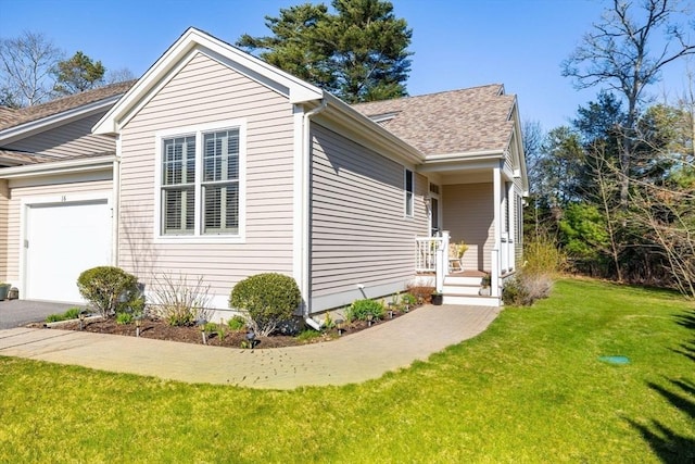 view of home's exterior featuring a yard, an attached garage, a shingled roof, and driveway