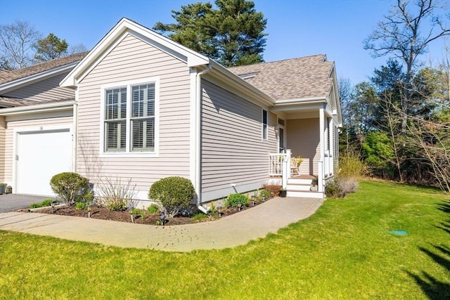view of home's exterior with an attached garage, a shingled roof, driveway, and a yard
